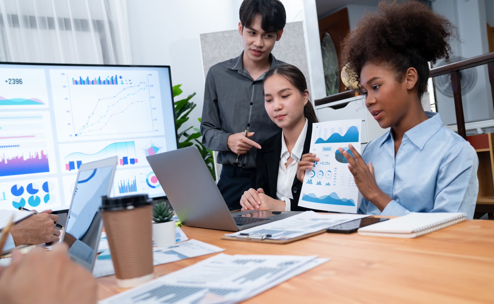 Multiracial analyst team reviewing SEO and marketing analytics dashboards