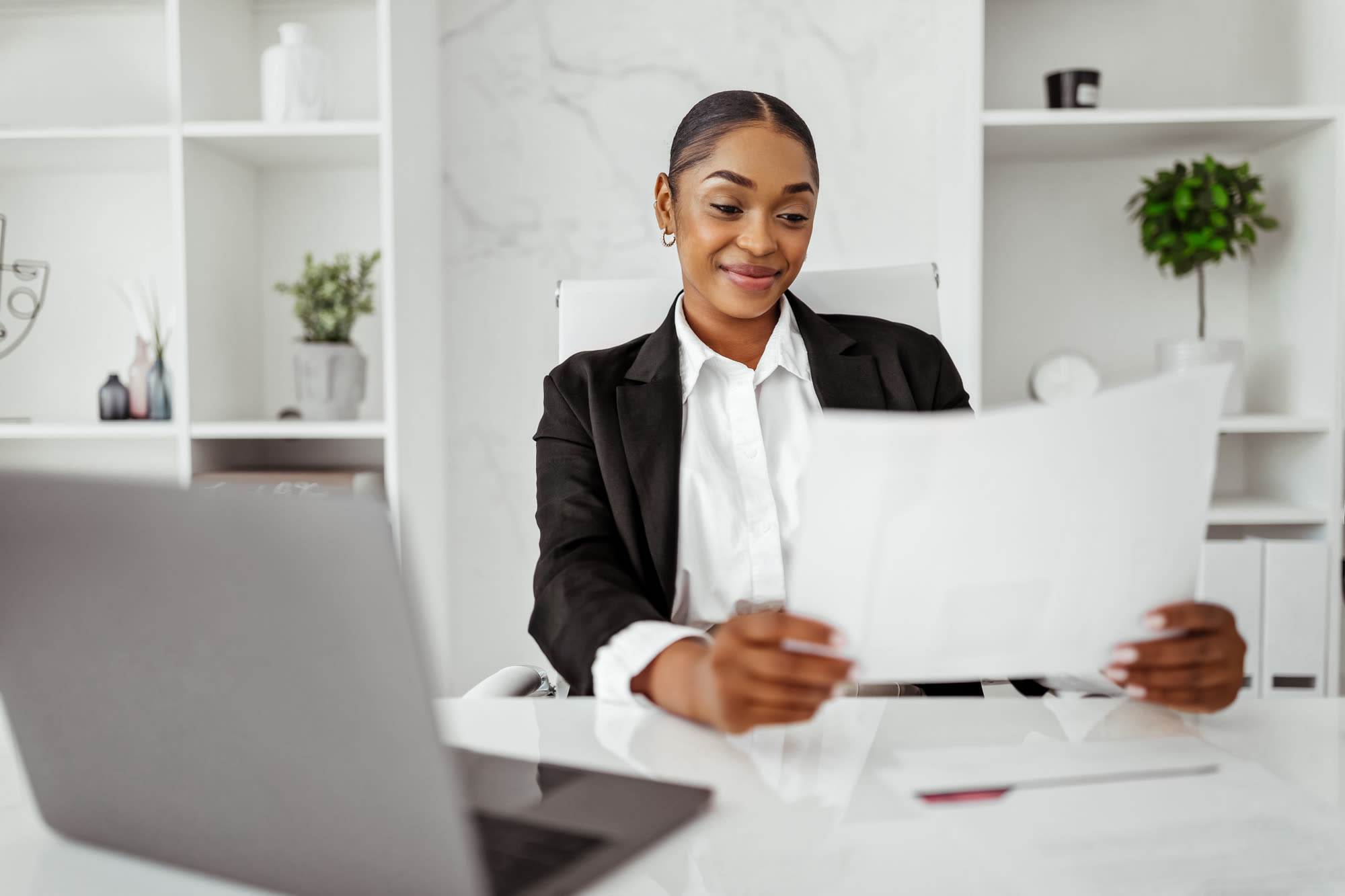 Black female entrepreneur reviewing business documents